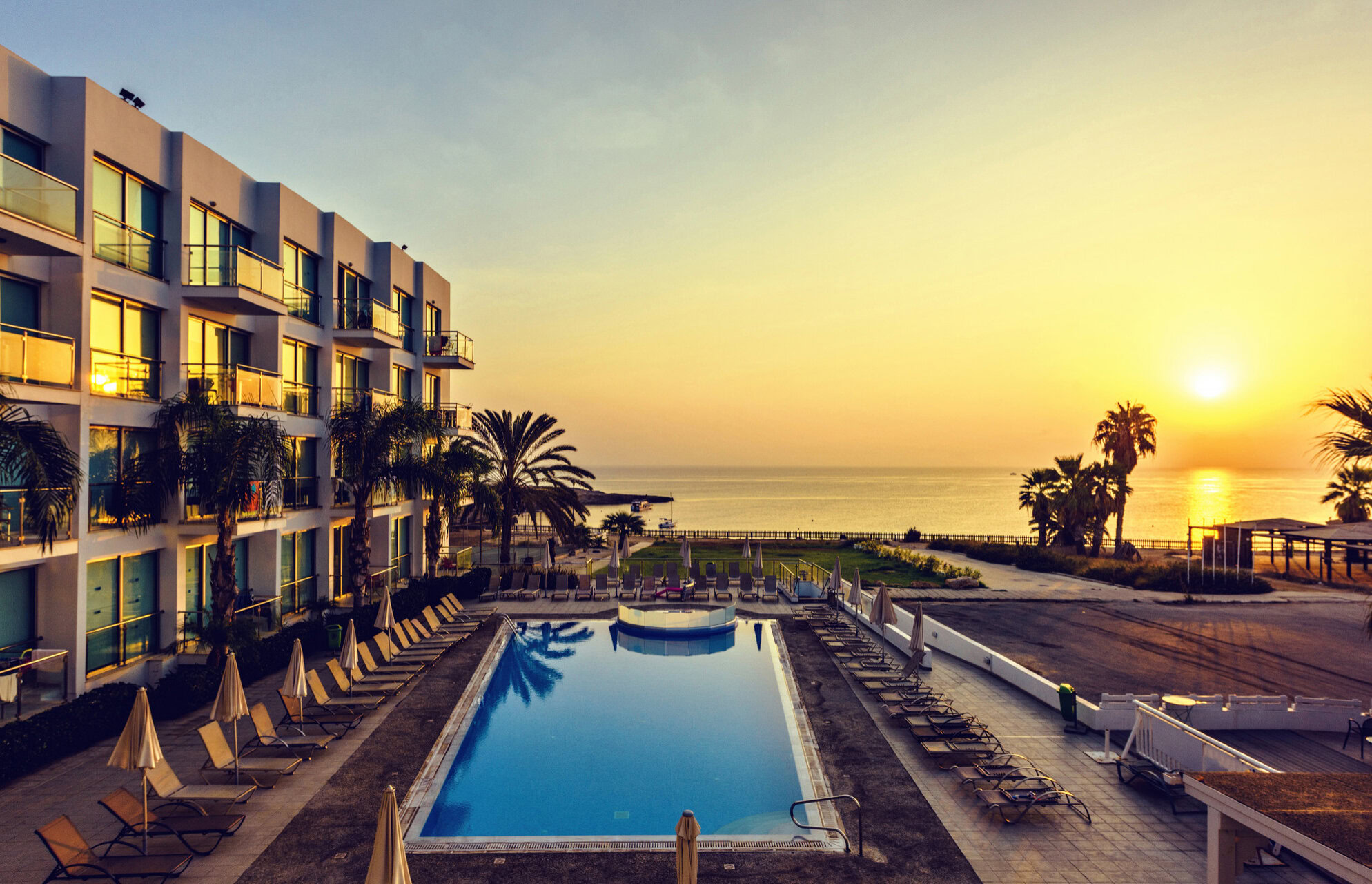 Outside hotel swimming pool at sunset